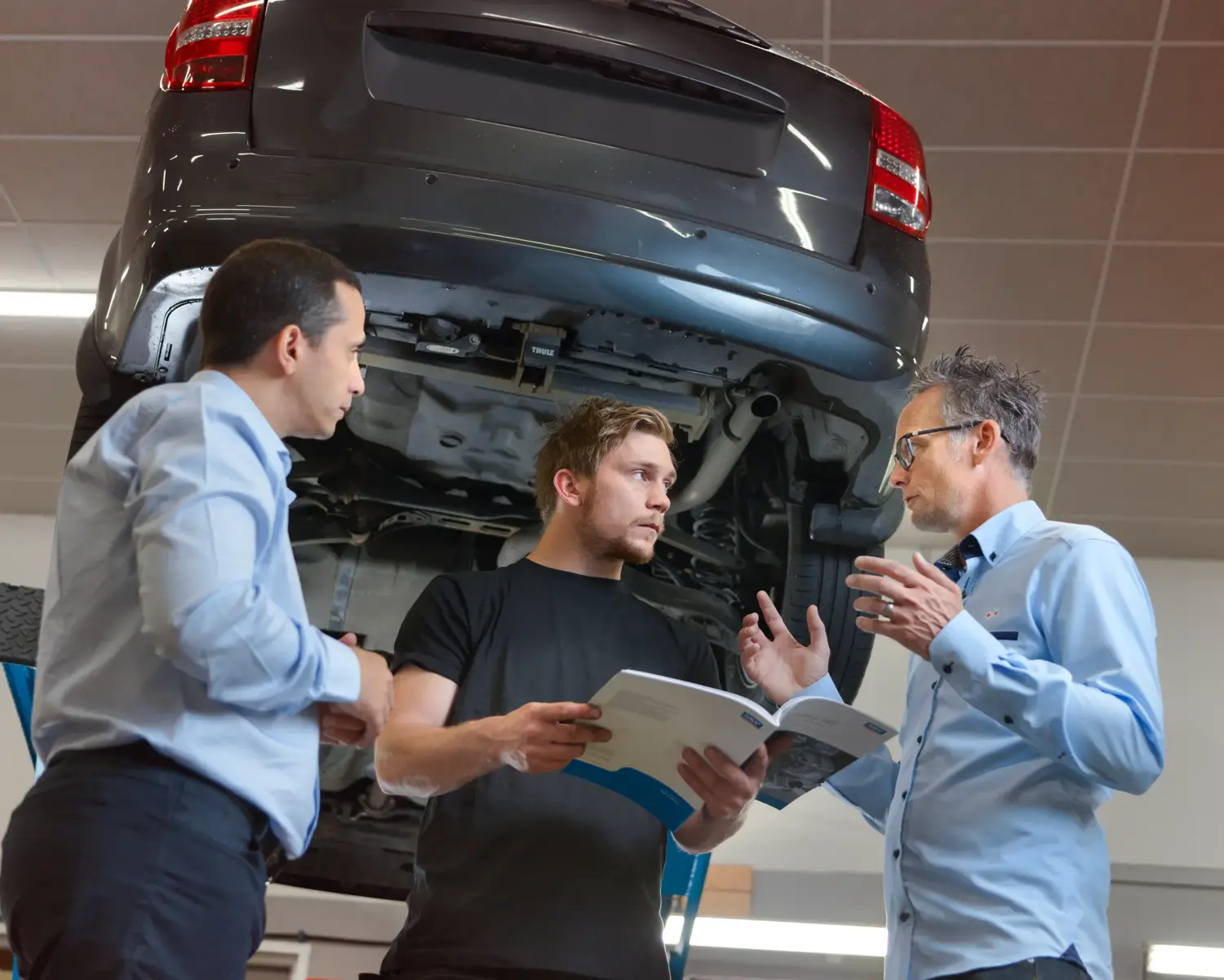 Customer and dealer in garage iPad product selection